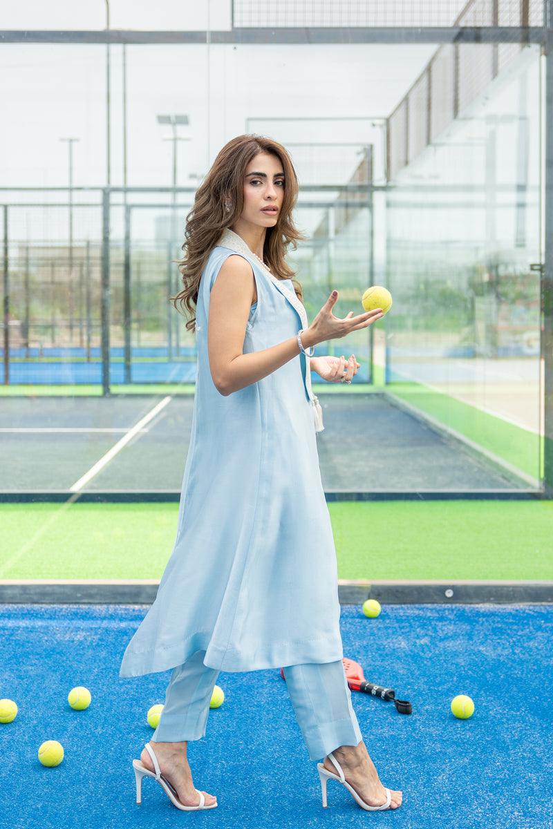 Pearl white Dori embroidery on ice blue silk cape paired with straight pants.